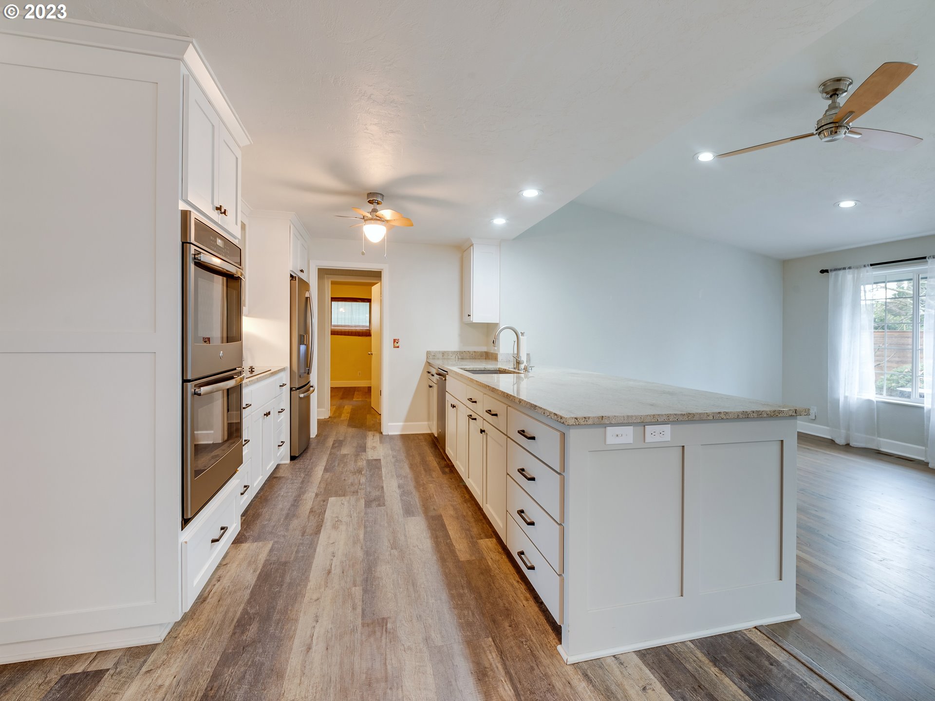2552 Jasmine Street Eugene, OR 97404 - Photo 8 of 24 a open kitchen with cabinets a sink and wooden floor