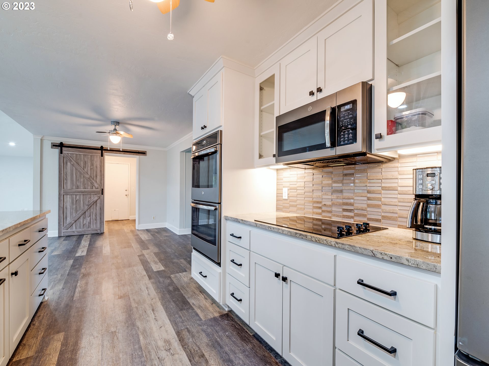2552 Jasmine Street Eugene, OR 97404 - Photo 10 of 24 a kitchen with stainless steel appliances granite countertop a stove microwave and cabinets