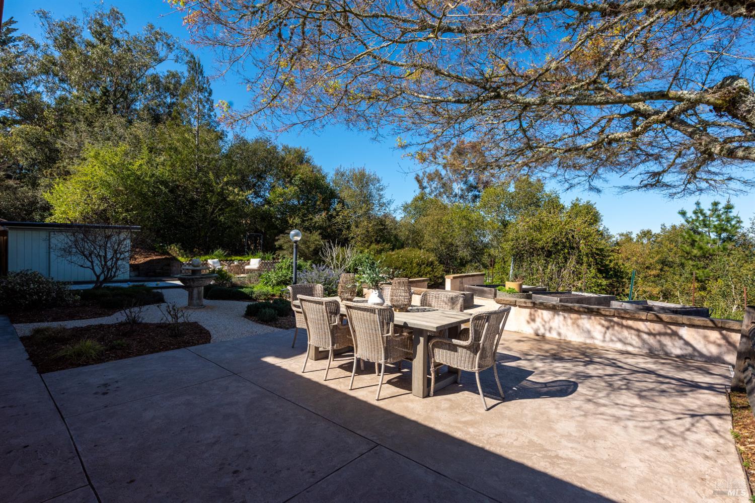 2405 Lewis Road Sebastopol, CA 95472 - Photo 57 of 58 a view of a patio with dining table and chairs with wooden fence and floor