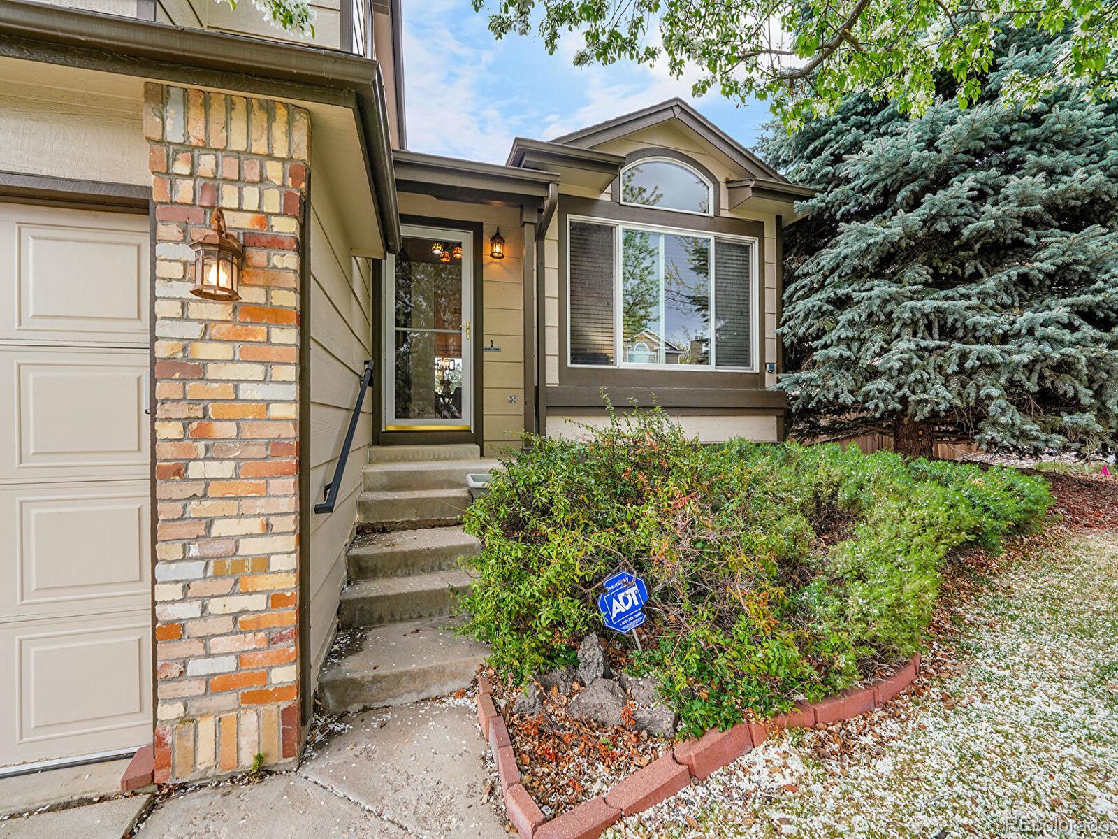 6343 Laguna Circle Highlands Ranch, CO 80130 - Photo 12 of 43 a front view of a house with a yard