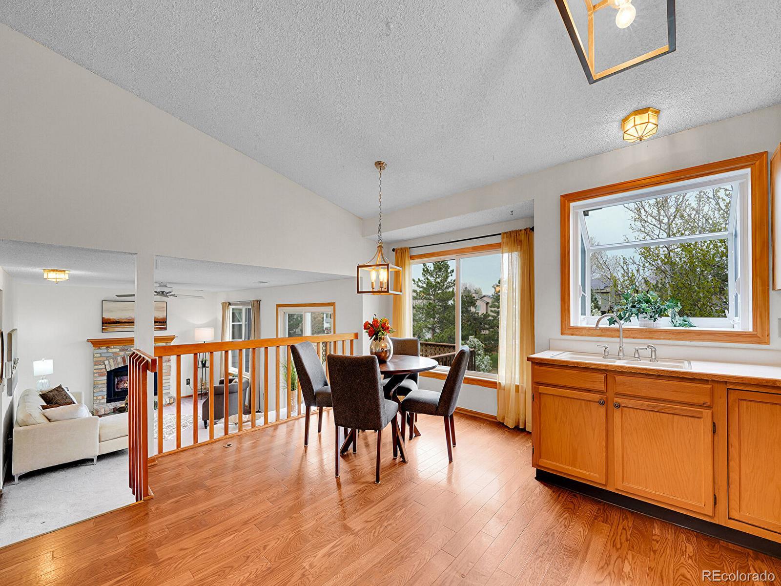 6343 Laguna Circle Highlands Ranch, CO 80130 - Photo 16 of 43 a view of a dining room with furniture and chandelier