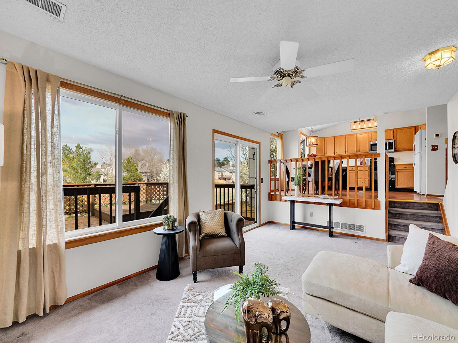 6343 Laguna Circle Highlands Ranch, CO 80130 - Photo 17 of 43 a living room with furniture and a large window