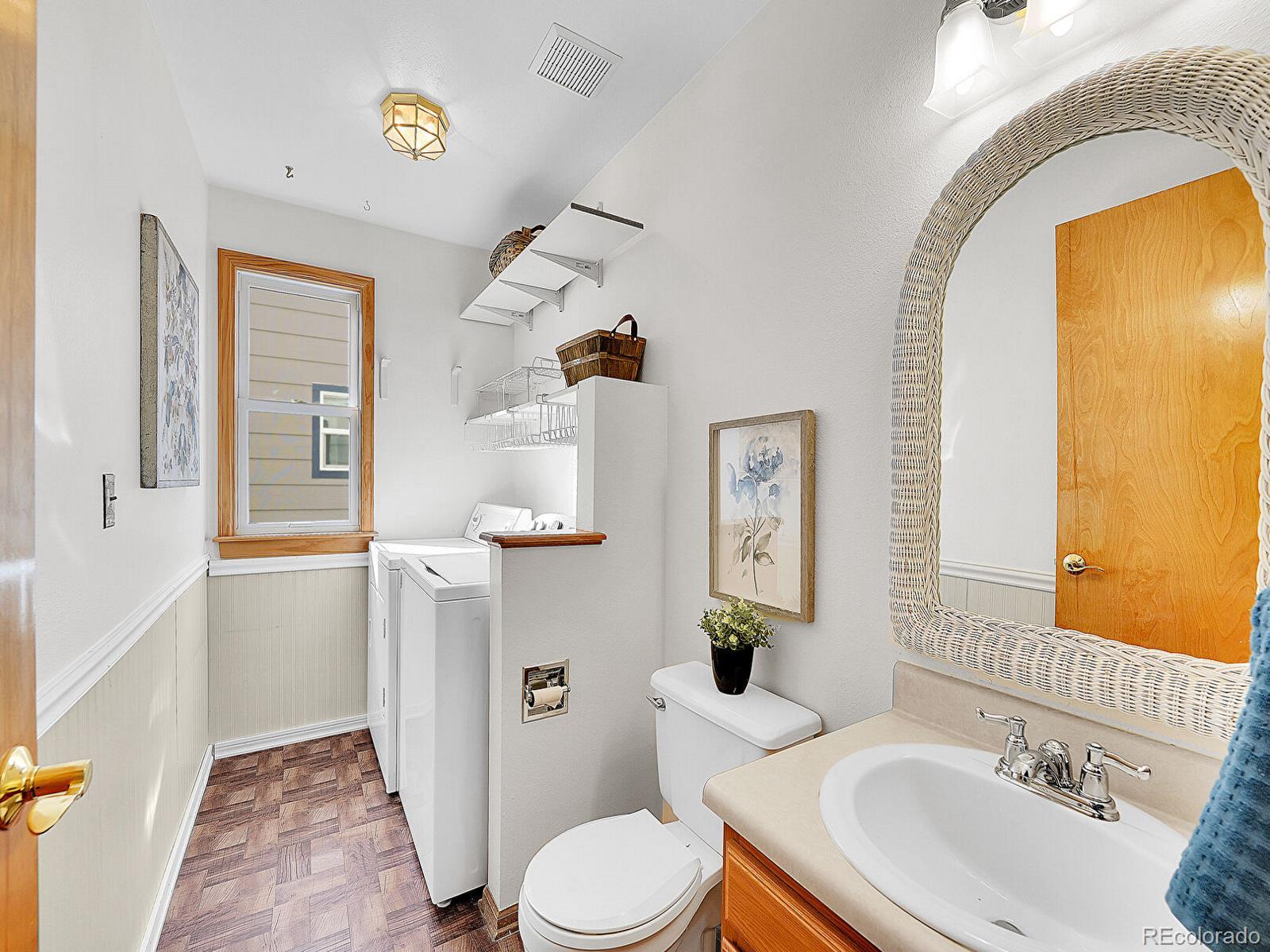 6343 Laguna Circle Highlands Ranch, CO 80130 - Photo 22 of 43 a bathroom with a sink mirror vanity and toilet