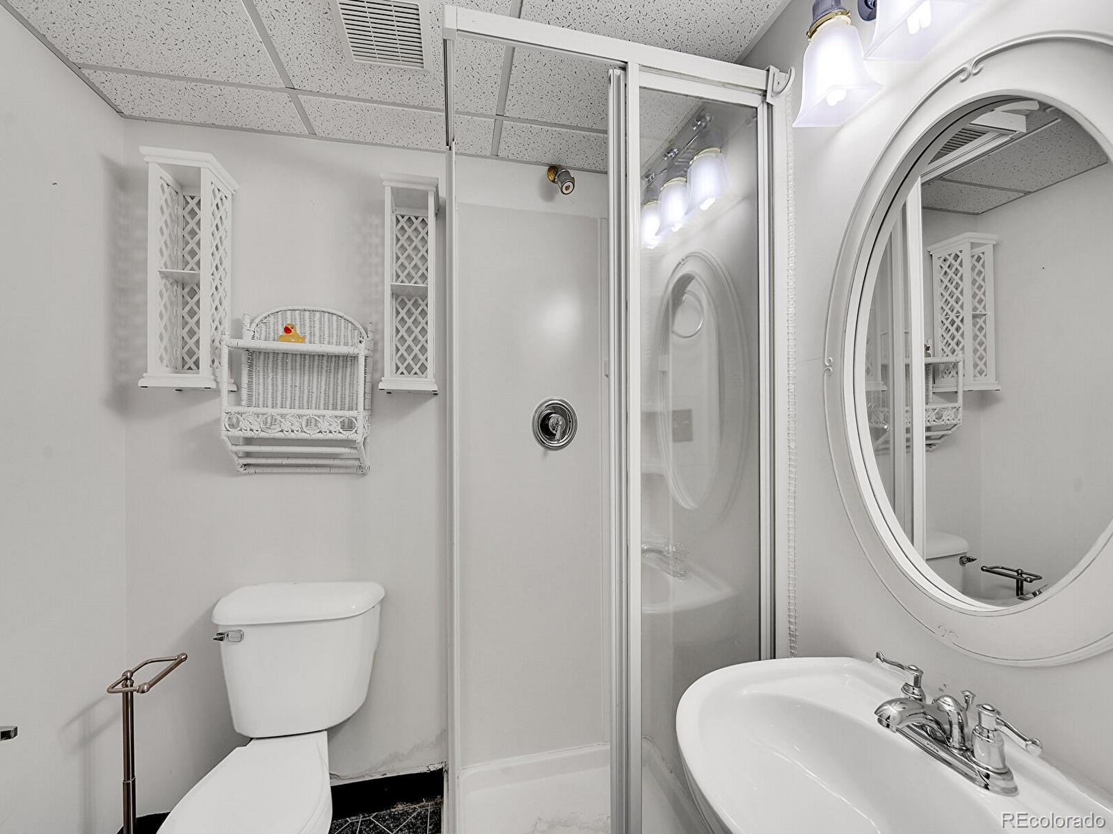 6343 Laguna Circle Highlands Ranch, CO 80130 - Photo 27 of 43 a bathroom with a toilet a sink and shower