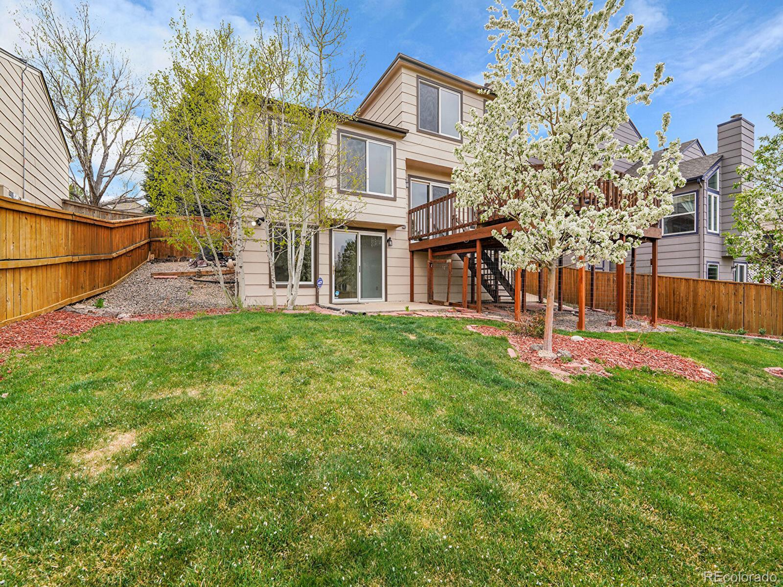 6343 Laguna Circle Highlands Ranch, CO 80130 - Photo 29 of 43 a view of a house with a yard and sitting area