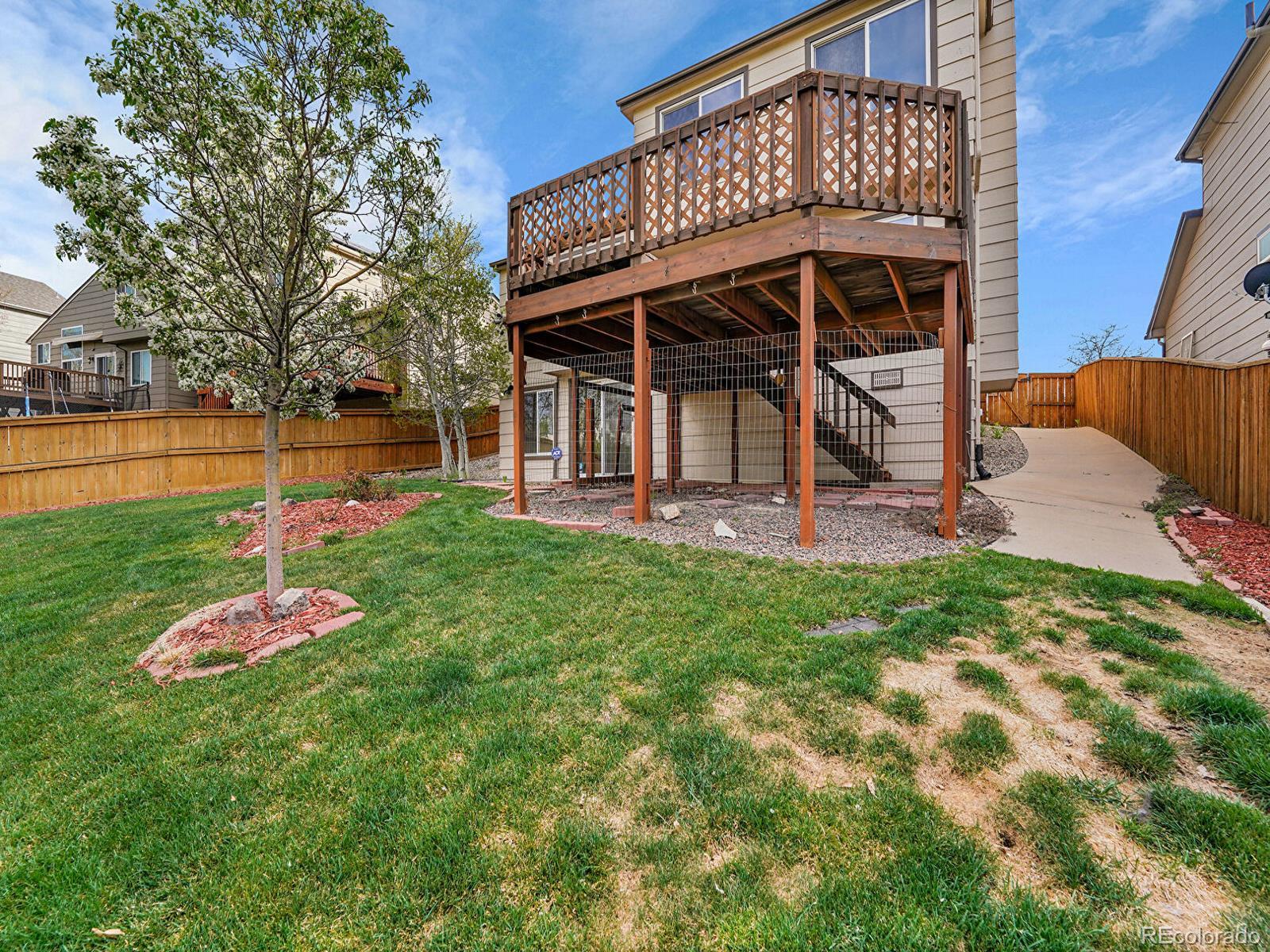 6343 Laguna Circle Highlands Ranch, CO 80130 - Photo 30 of 43 a view of a backyard with table and chairs and potted plants