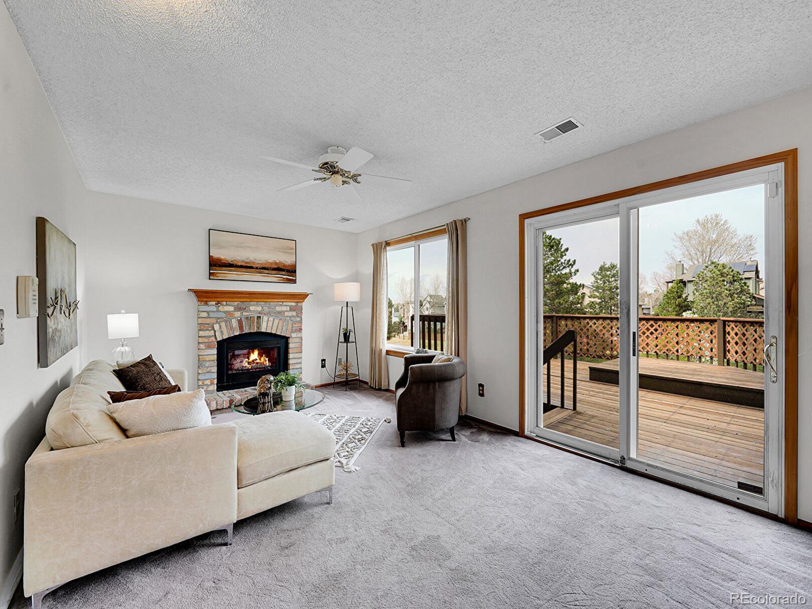 6343 Laguna Circle Highlands Ranch, CO 80130 - Photo 4 of 43 a living room with furniture and a fireplace