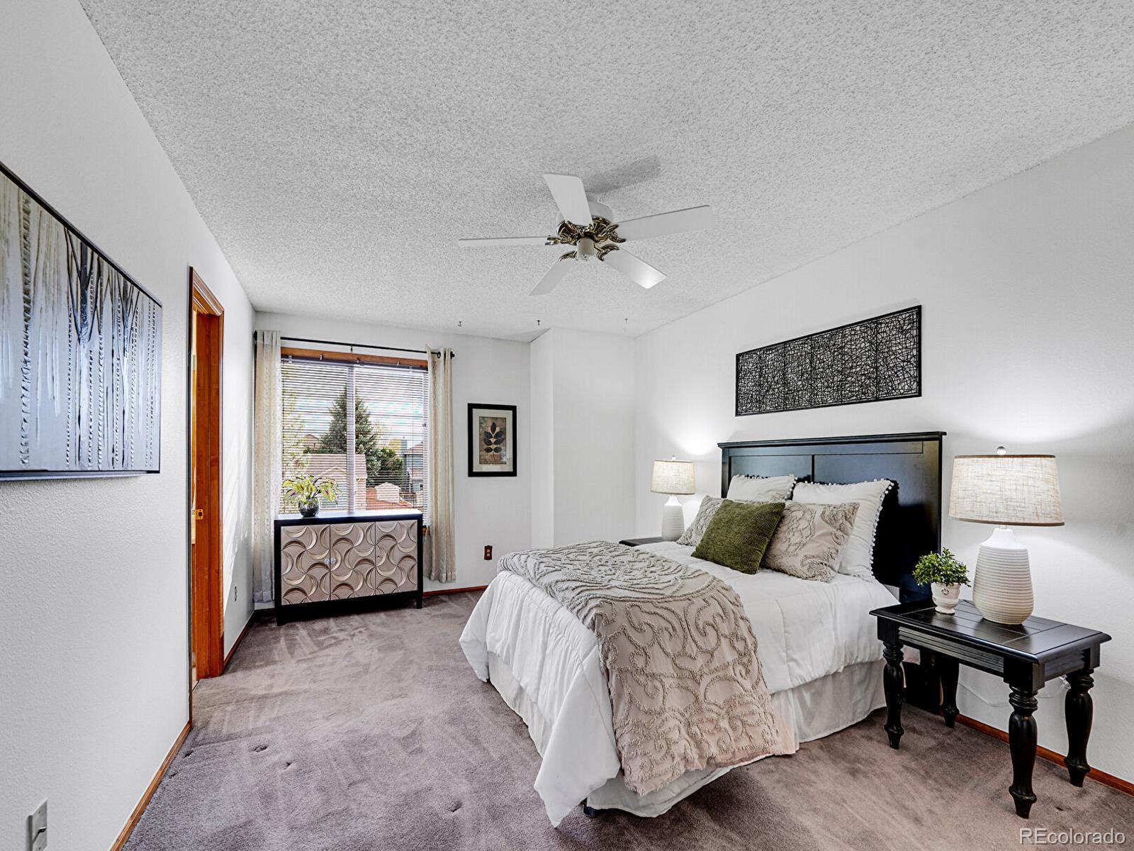 6343 Laguna Circle Highlands Ranch, CO 80130 - Photo 7 of 43 a bedroom with a bed and a table