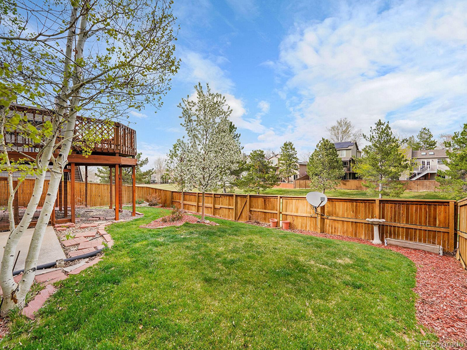 6343 Laguna Circle Highlands Ranch, CO 80130 - Photo 10 of 43 a view of a garden with a slide