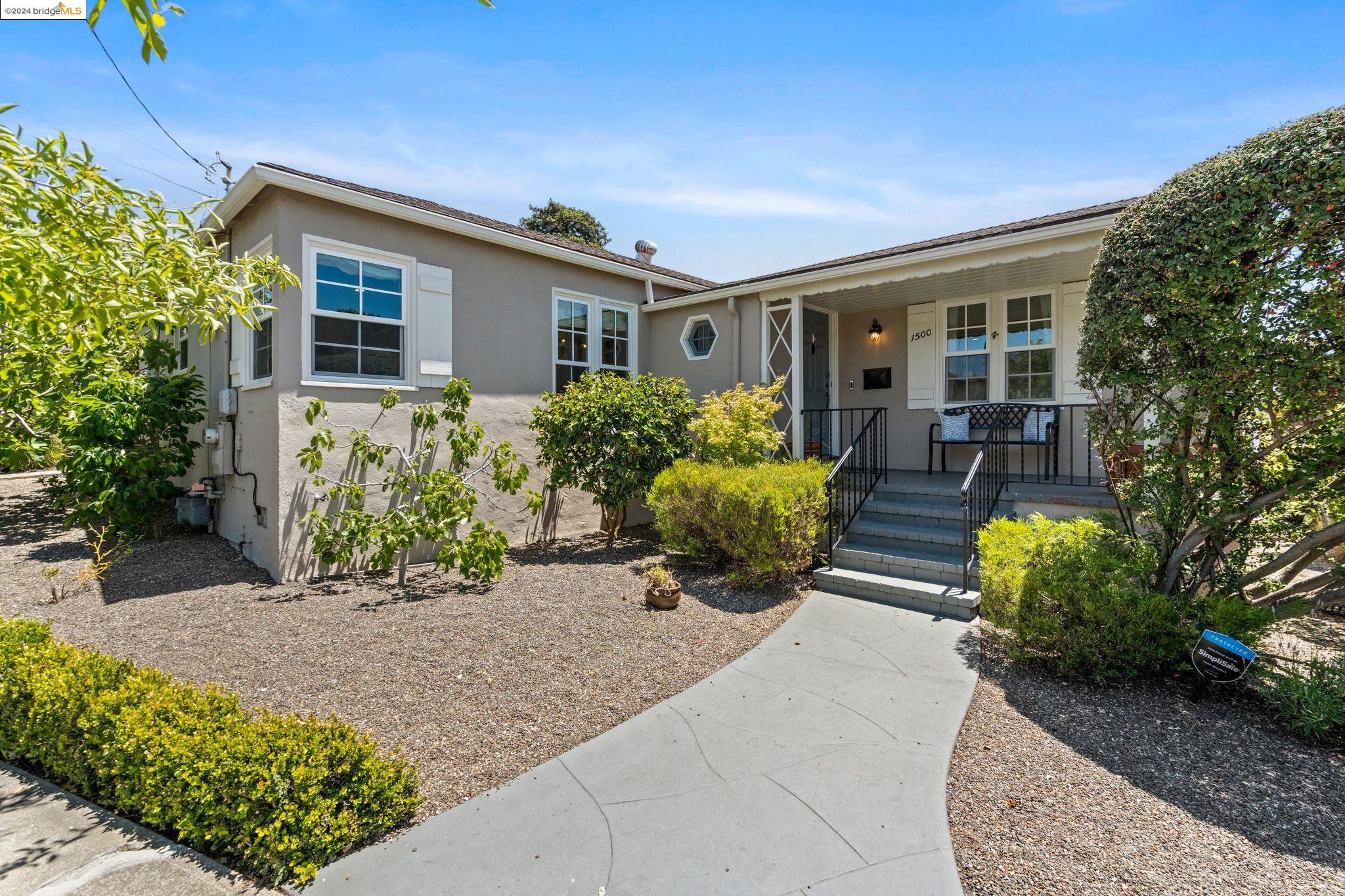 front view of a house with potted plants
