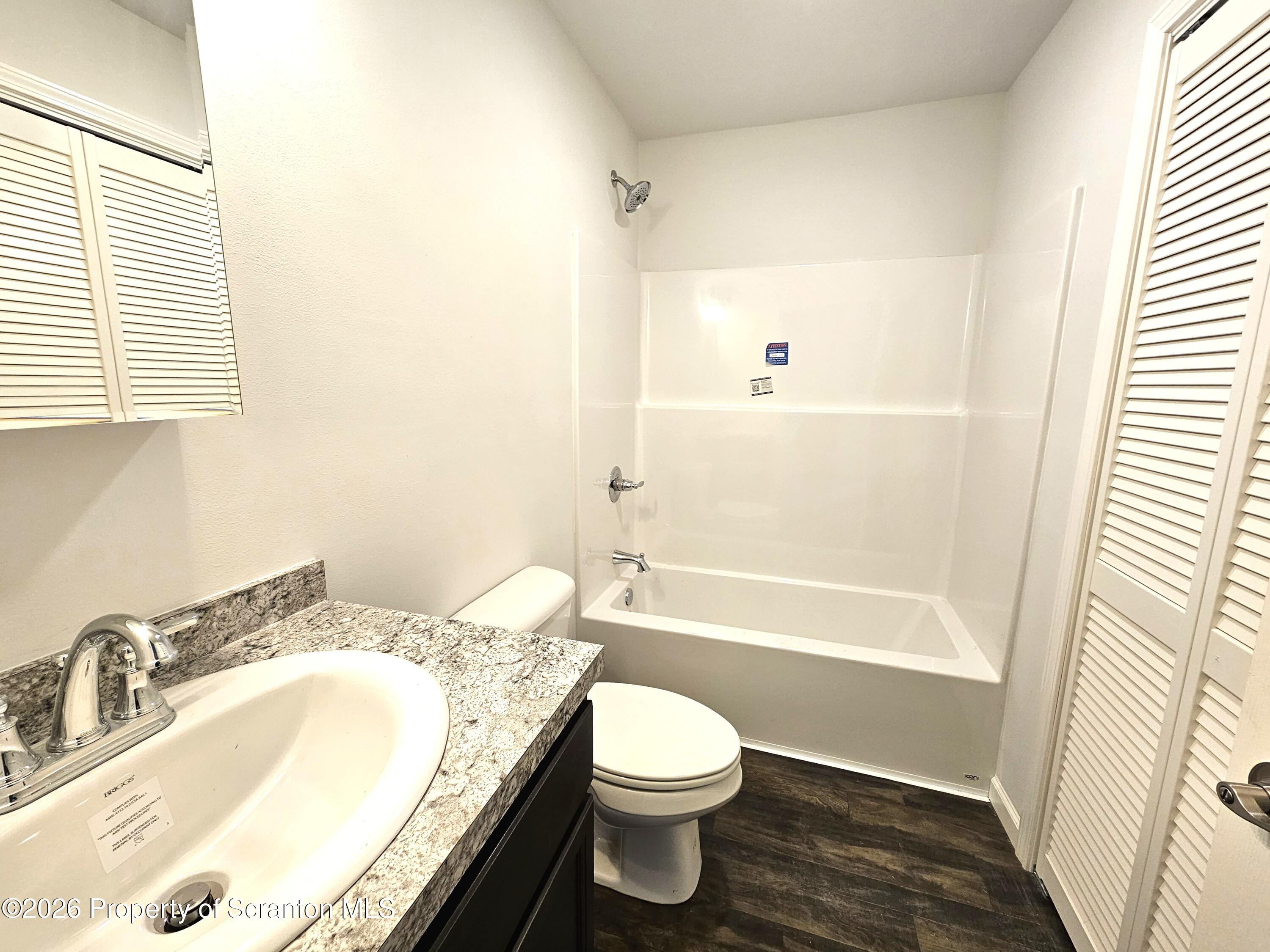 609 East Gibson Street, Unit 1 Scranton, PA 18510 - Photo 4 of 9 a bathroom with a granite countertop sink toilet and shower