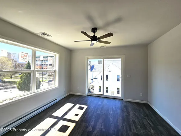 a very nice looking room with wooden floor and a window