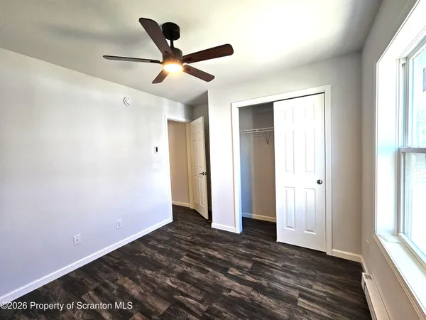 wooden floor in an empty room with a window