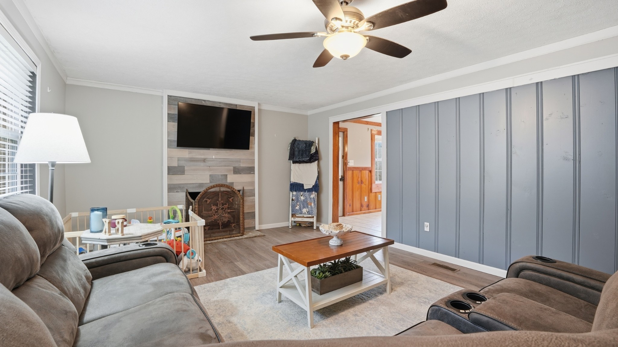 7610 Highway 50 Pelham, TN 37366 - Photo 12 of 46 a living room with furniture a flat screen tv and a fireplace