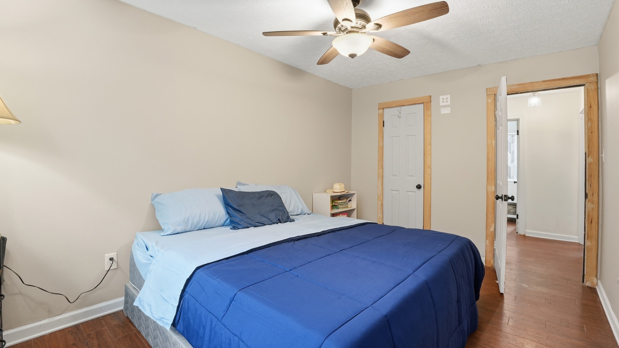 7610 Highway 50 Pelham, TN 37366 - Photo 20 of 46 a bedroom with a large bed and a chandelier