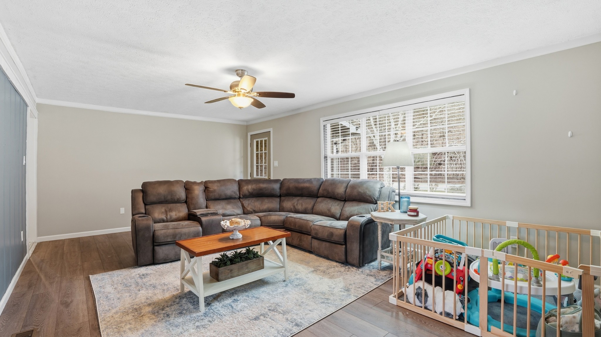7610 Highway 50 Pelham, TN 37366 - Photo 8 of 46 a living room with furniture a baby crib and a chandelier
