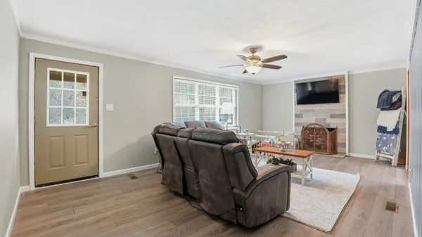 a living room with furniture a fireplace and a flat screen tv