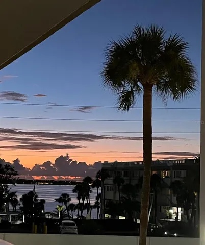 a kitchen with stainless steel appliances a refrigerator sink and white cabinets