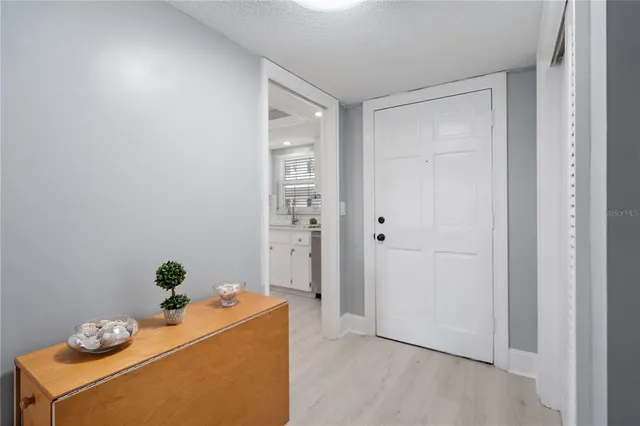 a kitchen with a refrigerator a sink dishwasher a stove and a oven with wooden floor