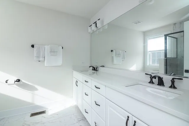 a bathroom with a tub sink and mirror