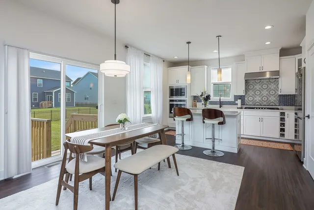 a dining room with furniture and wooden floor