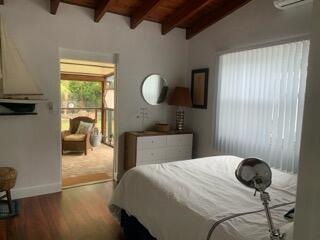 919 Lobster Lane Key Largo, FL 33037 - Photo 12 of 21 a bedroom with a bed and a chandelier