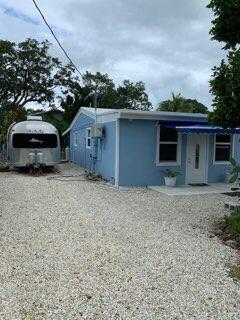 919 Lobster Lane Key Largo, FL 33037 - Photo 2 of 21 a front view of a house with a yard