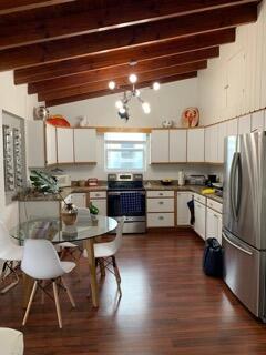 919 Lobster Lane Key Largo, FL 33037 - Photo 5 of 21 a kitchen with granite countertop a refrigerator a stove a sink and white cabinets with wooden floor