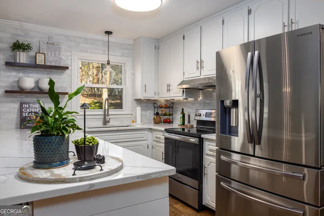 a kitchen with a refrigerator and a white cabinets