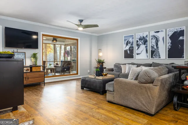 a living room with furniture and a flat screen tv