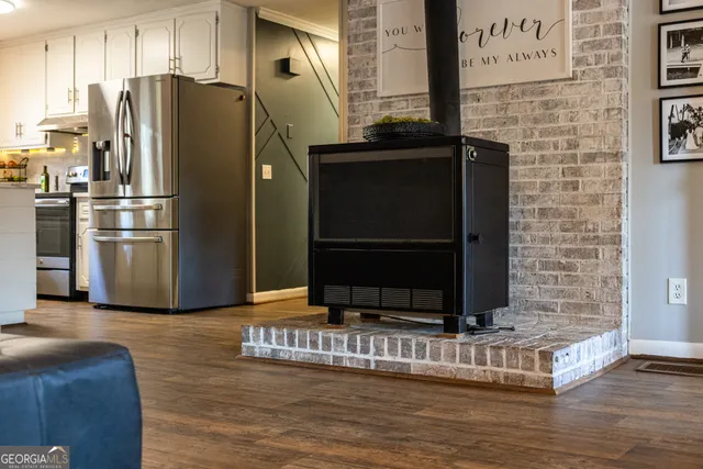 a kitchen with stainless steel appliances granite countertop a refrigerator and a stove