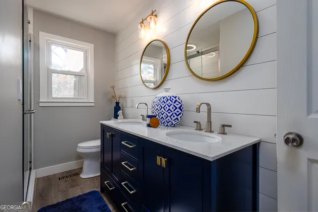 a bathroom with a toilet a sink and a mirror
