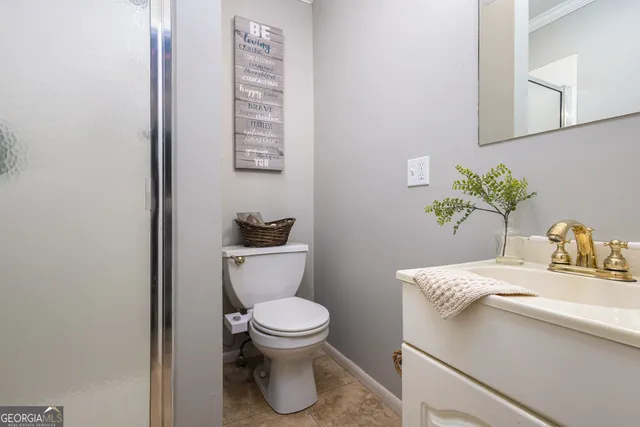 a white toilet sitting next to a bathroom sink