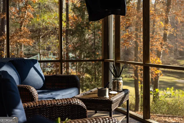 a balcony with wooden floor and furniture