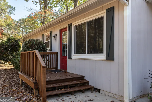 a view of a porch with wooden floor and fence