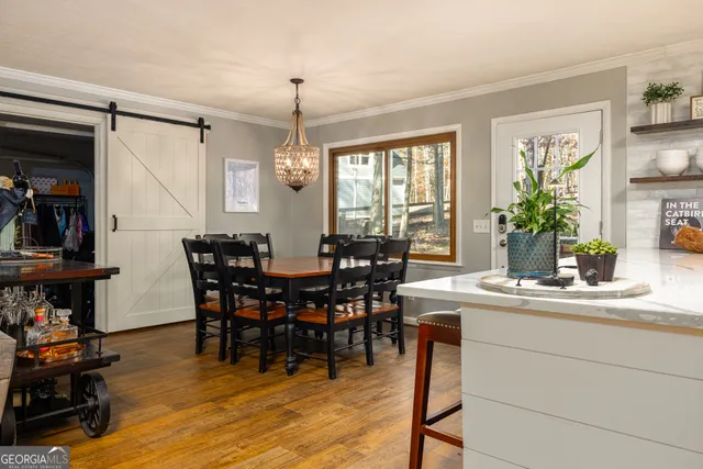 a view of a dining room with furniture and chandelier
