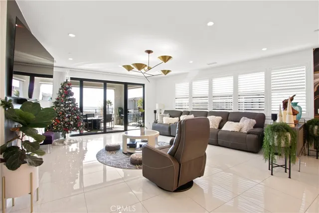 a living room with furniture a dining table and a large window