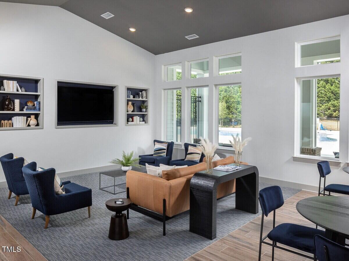 3520 Pinetree Grove Lane, Unit A1 Raleigh, NC 27604 - Photo 11 of 26 a living room with furniture a flat screen tv and a large window