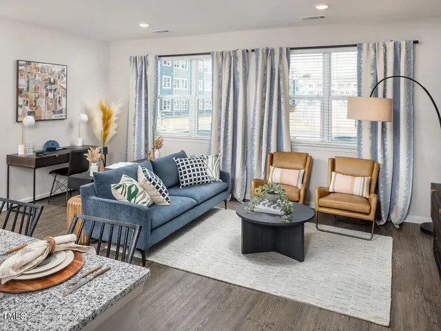 a kitchen with stainless steel appliances granite countertop a stove top oven a sink dishwasher and a microwave with wooden floor