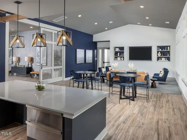 a open kitchen with stainless steel appliances granite countertop a stove and refrigerator