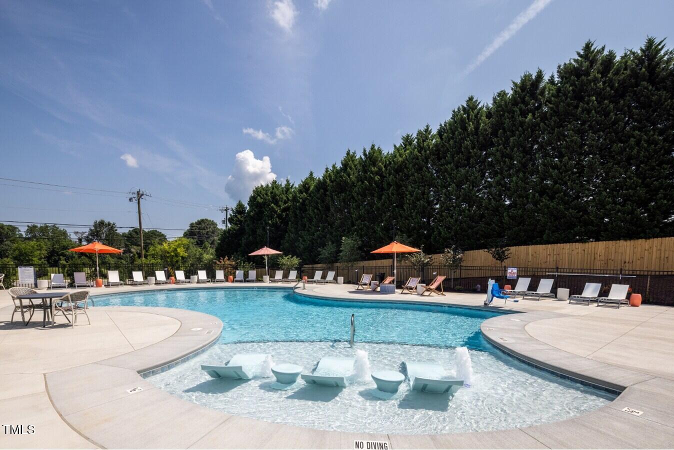 3520 Pinetree Grove Lane, Unit A1 Raleigh, NC 27604 - Photo 26 of 26 a view of a swimming pool and lounge chairs