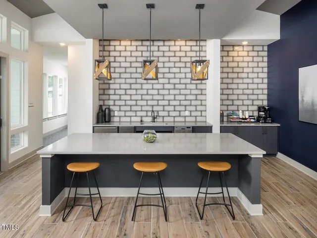 a kitchen with a table chairs and a wooden floor