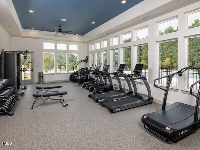 a room with gym equipment and a large window