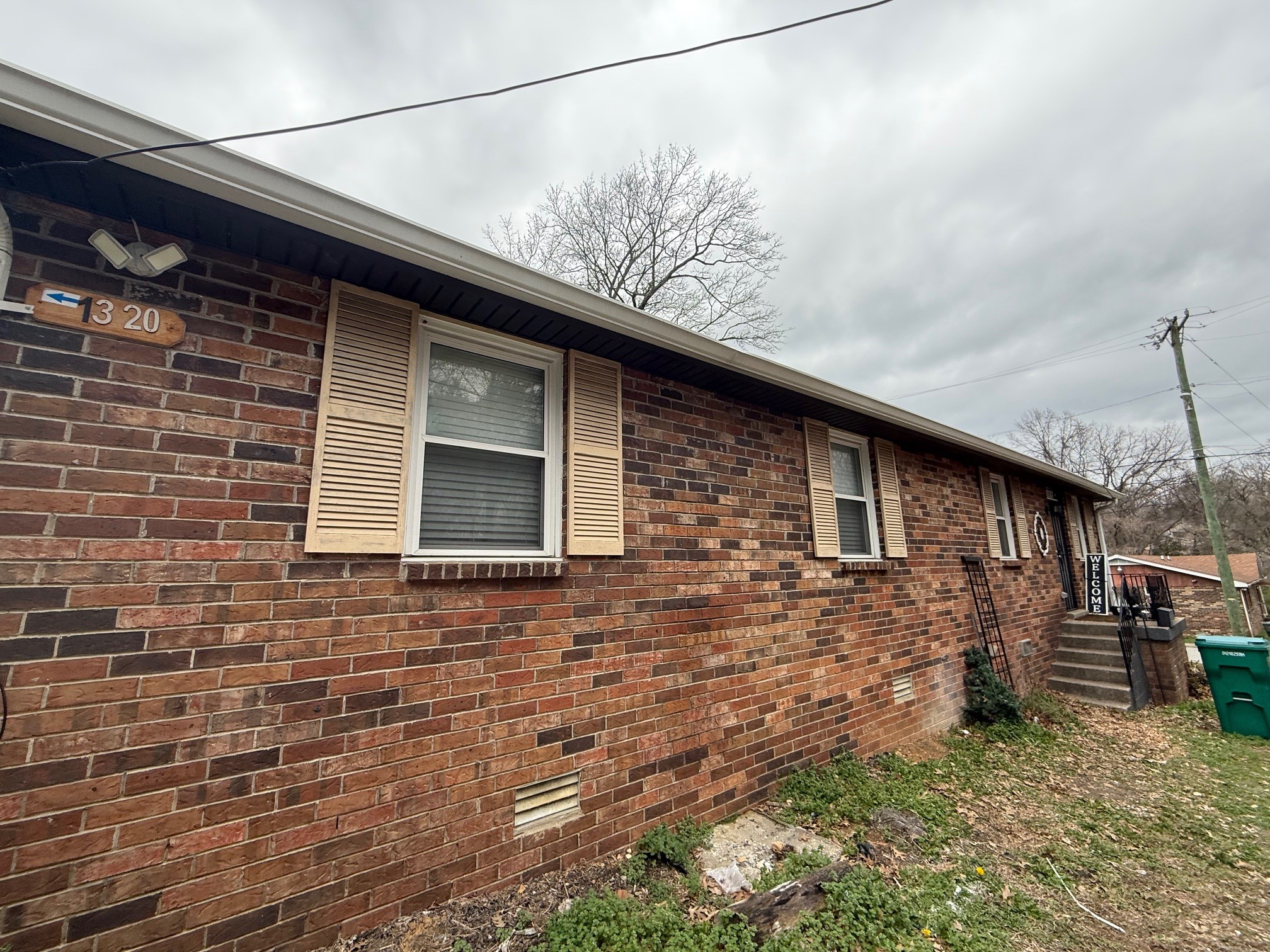 1320 Tulip Grove Road Hermitage, TN 37076 - Photo 6 of 6 a brick building with a bench in front of it