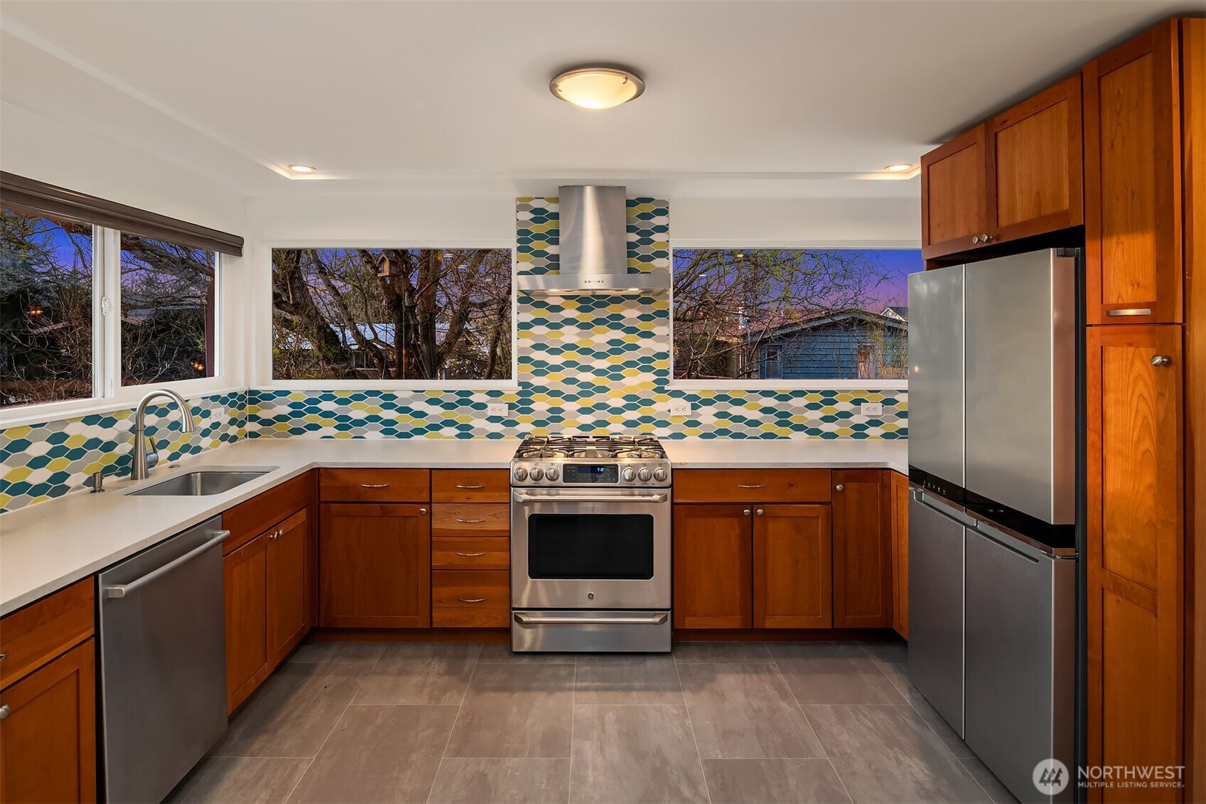 4846 South Juneau Street Seattle, WA 98118 - Photo 11 of 38 a kitchen with stainless steel appliances a stove sink and refrigerator