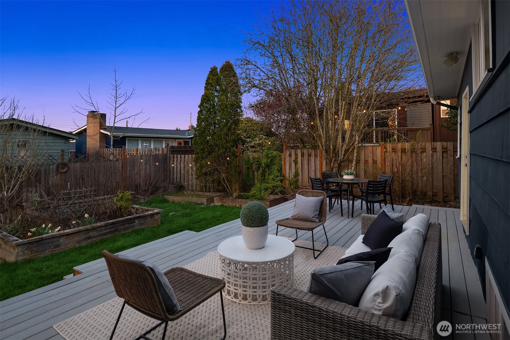 4846 South Juneau Street Seattle, WA 98118 - Photo 30 of 38 a view of a patio with couches chairs and a fire pit with wooden fence