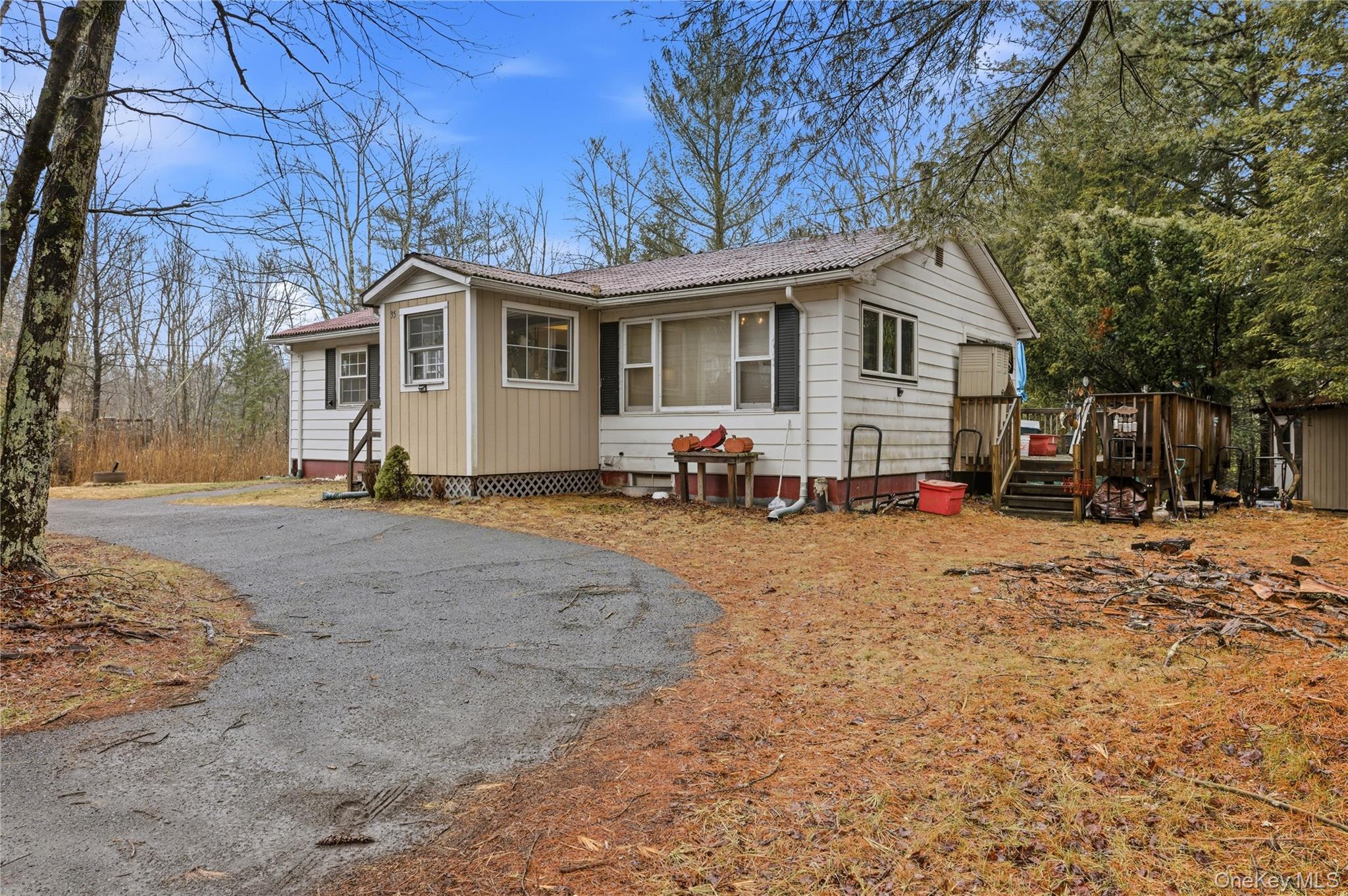 35 Quiat Road Mountain Dale, NY 12763 - Photo 24 of 27 View of front facade with a storage unit, asphalt driveway, and a wooden deck