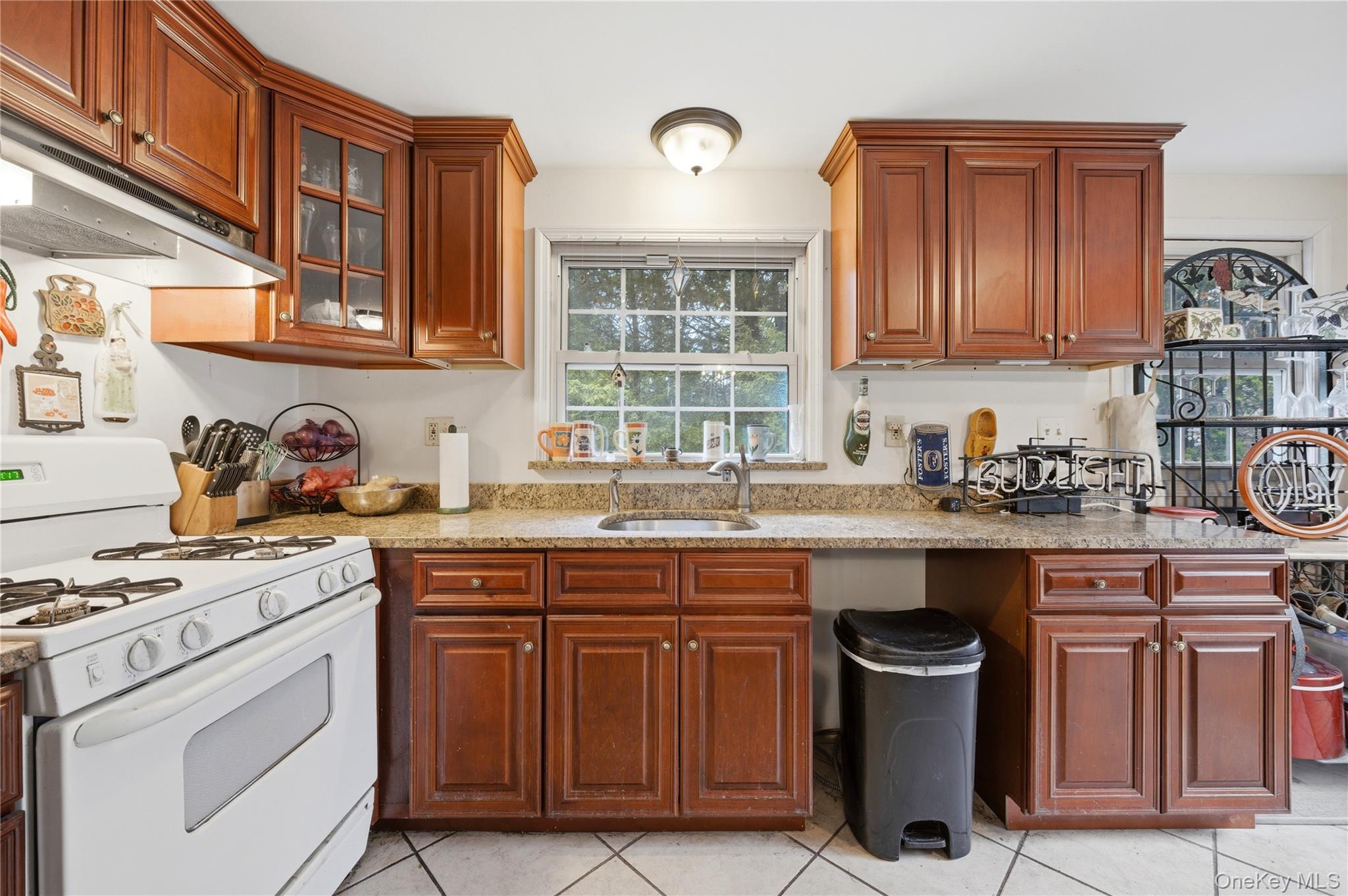 35 Quiat Road Mountain Dale, NY 12763 - Photo 6 of 27 Kitchen featuring white range with gas cooktop, glass fronted cabinets, light stone countertops, wood finish cabinets, and light tile patterned flooring
