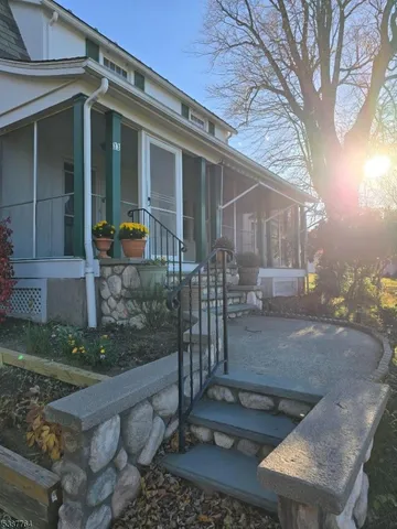 a backyard of a house with fountain table and chairs