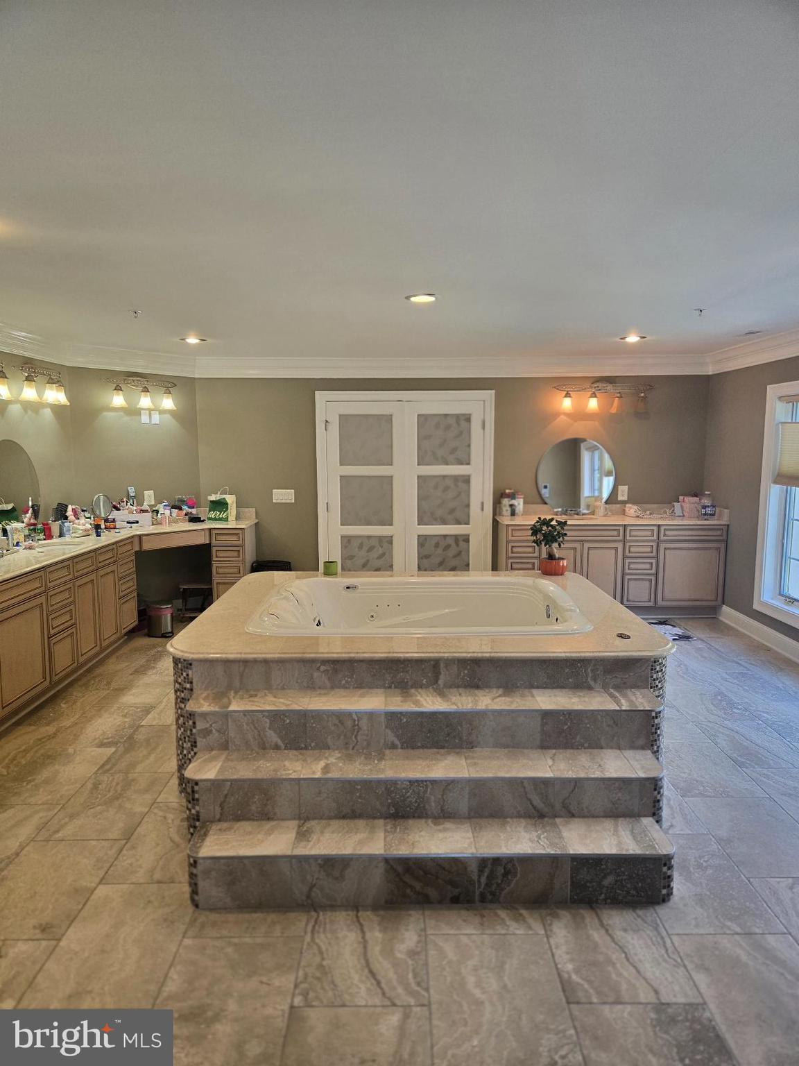 7145 Brooks Road Highland, MD 20777 - Photo 35 of 89 a spacious bedroom with a large bed and a chandelier